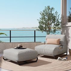 a living room with an ocean view and two chairs on the floor next to each other