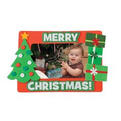 a merry christmas frame with a baby in front of a tree and presents on it