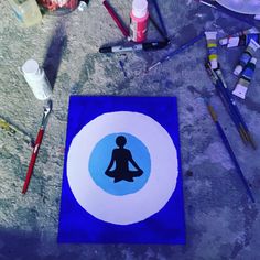 a blue and white mat with a silhouette of a person sitting in a yoga pose