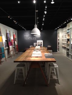 a table with chairs and books on it in a room