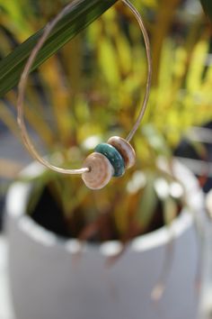 2 puka shells with a dark green jade ring Green Shell Jewelry For Beach, Ocean-inspired Green Jewelry For Vacation, Green Ocean-inspired Jewelry For Vacation, Green Shell Bohemian Jewelry, Bohemian Green Shell Jewelry, Handmade Beachy Green Jewelry, Green Handmade Shell Jewelry, Handmade Green Shell Jewelry, Green Beachy Jewelry For Vacation