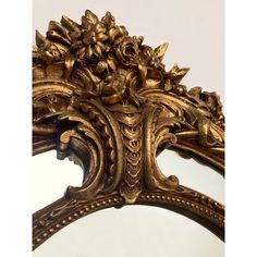 an ornate gold mirror with flowers on it