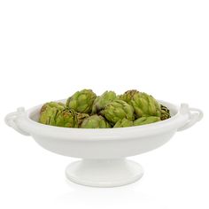 a white bowl filled with green artichokes