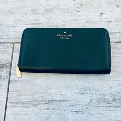 Kate Spade Deep Evergreen Pebble Leather Large Continental Wallet New Never Used No Blemishes No Stains Staci Collection Color Is Deep Evergreen (961) Ivy Green Pebble Leather Large Wallet With Zip Closure 12 Credit Card Slots 2 Interior Slip Pockets 3 Billfold Interior Pockets Green Spade Logo Fabric Interior Interior Zip Pocket Back Exterior Slip Pocket Gold Pin Mounted Spade Logo Gold Hardware Measurements 3.9" H X 7.6" W Tag And Care Card Included Happy Poshing! Classic Green Wallet For Daily Use, Green Leather Wallet With Zipper Closure, Green Leather Travel Wallet, Green Leather Wallets With Zipper Closure, Elegant Green Wallets With Card Slots, Elegant Green Bifold Wallet, Elegant Green Wallets For Travel, Kate Spade Wallet Pink, Spade Logo