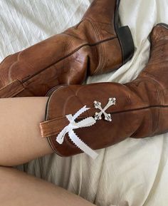 a woman's legs and boots with lace on them