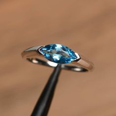 It is a Swiss blue topaz ring. The main stone is 5 mm* 10 mm marquise cut.weight about 1.24 carats.The basic metal is sterling silver and plated with rhodium.To change the metal to a solid gold (white/rose) or platinum is also available, please ask for a quotation if you want.You can also go to my shop Home for more elegant rings: https://www.etsy.com/shop/godjewelry?ref=hdr_shop_menu Swiss blue topaz is November birthstone More Swiss blue topaz rings:https://www.etsy.com/shop/godjewelry?ref=sel Rainbow Topaz Ring, Blue Aquamarine Ring, March Birthstone Ring, Swiss Blue Topaz Ring, Mystic Topaz Ring, Liberty Blue, Silver Engagement Ring, Ring Marquise, Aquamarine Engagement Ring