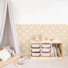 a child's playroom with toys and storage bins in front of the wall