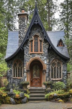 Gothic stone cottage with ornate windows and arched doorway. Enter a world where whimsical charm meets shadowy intrigue, as this article unveils the enchantingly moody essence of dark cottagecore houses. Arched Cottage Door, Witch Cottage Exterior, Story Book House, Cottage Home Exterior, Cottagecore Houses, Whimsical Architecture, Dark Cottagecore House, Woodland Path, Arched Doorway