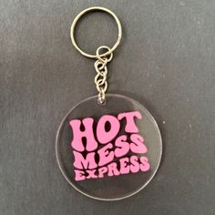 a keychain with the words hot mess express written on it in pink ink