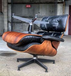 an eames chair and ottoman in black leather