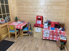 a room with wooden walls and wood flooring is decorated in red and white checkered table cloths