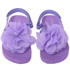 A cute pair of sandals for your toddler girl. These purple flip flop style sandals feature a sequin accented strap and attached fabric flower. Adjustable strap at the ankle help with fit and comfort.