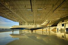 an airplane is parked in a large hangar