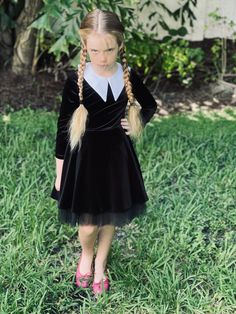 Dive into a blend of whimsical charm and gothic allure with our Gothic Inspired Halloween Dress - the perfect little black gothic dress and Halloween costume for every little dreamer. Whether attending a cosplay event, Halloween festivities, or a carnival parade, this dress exudes unique gothic inspiration Made with a comfortable velour material in a rich black hue, this witch girl dress isn't just about aesthetics; it's designed keeping your child's comfort in mind. The tulle skirt and satin lining elevate the dress's splendor, making it the ideal choice for any event, be it a themed birthday party or a Christmas celebration. The versatility of this dress is its charm. It's a perfect blend of a classic little black dress and a cosplay costume, making it suitable for various occasions. Pai Black Fitted Dress For School, Fitted Black Dress For School, Spooky Black Party Dress, Black Emo Dress For Costume Party, Black Spooky Party Dress, Vampire Style Party Dress For Fall, Fairy Grunge Halloween Costume Dress, Gothic Dress For Halloween, Black School Dresses For Fall