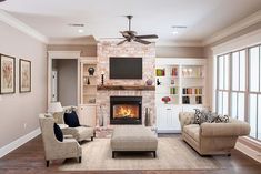 a living room filled with furniture and a fire place under a tv mounted on a wall