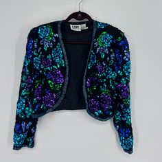 Niteline Women's Floral Sequin Beaded Cropped 100% Silk Jacket Purple Blue Large Nwot New Without Tag Brand: Niteline Color: Purple Blue Size: Large Open Front Long Sleeve Sequin Beaded All-Over Crop Length Lined 100% Silk Spot Clean Elegant, Chic, Fashionable, Stylish, Trendy, Sophisticated, Shimmer, Luxe, Glitzy, Statement, Glamorous, Party, Dressy, Evening, Vibrant Sku - 46h24.5.710 Blue Embellished Fitted Outerwear, Fitted Blue Embellished Outerwear, Spring Blue Beaded Outerwear, Fall Blue Beaded Outerwear, Blue Embellished Party Outerwear, Vintage Blue Outerwear For Party, Glamorous Party, Beaded Jacket, Long Sleeve Sequin