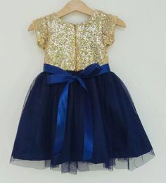 Flower girl dress gold and navy blue. The bodice is gold sequin with navy blue tulle skirt and navy blue satin ribbon belt. The inside of the dress is fully lined with cotton for a comfortable wear.Whether your girl will use it for a wedding attend dress, flower girl dress, Birthday Dress or to attend semi formal to formal occasion like Christmas Party, etc.. Let the girl feel like princess and shining in this gold and navy blue dressCustom Order Size: Please provide your child measurement: Ches Royal Tulle Dresses For Party, Royal Tulle Party Dresses, Gold Sequined Princess Dress For Wedding, Gold Princess Dress With Sequins, Elegant Gold Princess Dress With Sequins, Gold Glitter Tulle Princess Dress For Party, Gold Glitter Tulle Princess Dress For Wedding, Fitted Gold Princess Dress With Sequins, Princess Gold Glitter Tulle Dresses