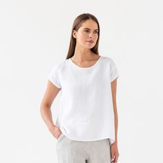 "Loose fit linen blouse TAHOE in white color is here to become your most loved piece for warm-weather outfits. Oversized, short sleeves, asymmetric hemline - our linen top has everything you need to feel chill & stylish. Perfectly suitable for summer escapes but equally works for an office look. Please note that actual colors may vary due to the many variations in monitors and browsers. DETAILS * Oversized silhouette * Short sleeves * Asymmetric hemline * True to size * Model is wearing size S a Relaxed Linen T-shirt, Everyday White Linen T-shirt, Linen Relaxed Fit Short Sleeve T-shirt, Linen Tshirt, White Linen Short Sleeve T-shirt, White Summer Yoga T-shirt, Wrinkled Clothes, Weather Outfits, Linen Tshirts