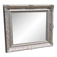 an ornate silver framed mirror on a white background