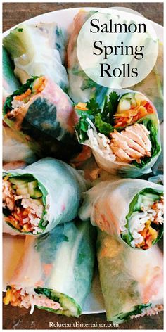 salmon spring rolls on a white plate with text overlay that reads salmon spring rolls