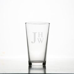 a shot glass with the initial jw on it