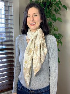 This Silky Bandana Scarf features Soft beige flowers and speckles on a warm light beige background. The options are endless with this Avenue Zoe Floral Speckled Printed Silky Bandana Scarf in Beige! It can be used as a bandana scarf, a beautiful hair wrap, tied as a top or to a handbag for extra flare. The 100% polyester material makes this bandana silky smooth, comfortable to wear as a headwrap or around the neck.Features:Style: Bandana, Hair WrapMaterial: 100% PolyesterColor/Pattern: Beige Flo Cream Floral Print Scarves For Spring, Beige Floral Print Scarves For Spring, Beige Floral Print Scarf For Spring, Bohemian Beige Scarves For Spring, Bohemian Beige Scarf For Spring, Light Beige Background, Style Bandana, Bandana Hair, Beige Flowers