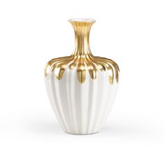 a white and gold vase sitting on top of a table