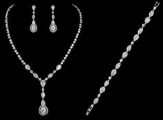 a diamond necklace and earring set on a black background with the word, diamonds written below it