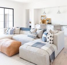 a living room filled with furniture and a large window