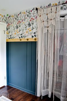 a room with blue walls and white curtains