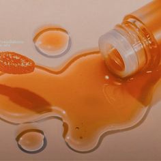 an orange liquid is spilling out of a bottle