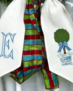 two towels hanging on the front door hangers with tree and monogrammed letters