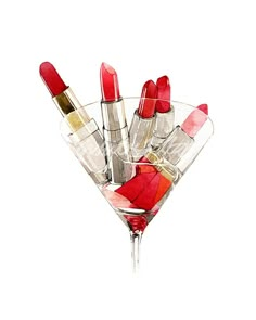 a martini glass filled with red lipstick and lipstick tubes in it's centerpiece