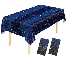 a blue table cloth with white stars on it and two matching place mats for the table