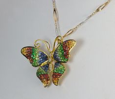 "IMPORTANT...CLICK ON DESCRIPTION OR DETAILS FOR SPECIFICATIONS JEWELRY STORE RETAIL....$6,557.00 SHE IS FAAAAR MORE STUNNING IN PERSON-FEMININE COLORFUL BUTTERFLY IS BOTH A PENDANT & BROOCH. If you love butterflies, this girl is gorgeous! As with many pretty butterflies, this girl has pretty colorful wings with shaded colors consisting of blue, yellow & orange Sapphires, deep green Tsavorite Garnets, & rich rubies. Her body sparkling white diamonds. She has large graceful feelers ad Elegant Multicolor Butterfly Necklace As A Gift, Elegant Multicolor Butterfly Necklace As Gift, Elegant Multicolor Butterfly Necklace Gift, Elegant Multicolor Jewelry With Butterfly Charm, Elegant Multicolor Butterfly Charm Jewelry, Multicolor Butterfly Charm Jewelry, Tsavorite Garnet, Gem Diamonds, All Gems