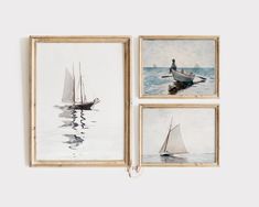 three framed paintings depicting sailboats in the water and one with a man standing on it