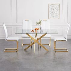 a glass dining table with white chairs around it