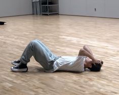 a man laying on the floor in an empty room