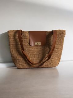 Any woman must have this bag for every fashionista. Whether you keeping it to yourself or gifting someone you care, it will be unforgettable. ✔️I made this beautiful bag from natural paper rope which is organic cotton and vegan leather in tan. ✔️The interior of the straw summer bag is fully lined with cotton and has a magnetic button. Suitable for use as shoulder bag, beach bag, travel bag or party bag. ✔️The bag has cotton lining. A lining of the appropriate color is sewn into the crochet paper bag. ✔️You can combine your clothes with a straw summer bag on summer days ✔️Matching colored leather accessories will be used for the bags you choose in different colours. (e.g. white for white, red for red) ✔️Handcrrafted in Turkey ✔️Hand-crocheted with care ✔️This bag is light weight yet durable Vacation Handheld Shoulder Bag With Leather Handles, Handheld Shoulder Bag With Leather Handles For Vacation, Elegant Tote Shoulder Bag For Beach Season, Elegant Crochet Tote Bag For Beach Season, Luxury Handwoven Straw Bag For Everyday Use, Luxury Handwoven Straw Bag For Daily Use, Large Capacity Jute Shoulder Bag For Travel, Chic Crochet Bag With Braided Handles For Travel, Chic Crochet Travel Bag With Braided Handles