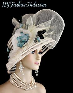 Women's Haute Couture Custom Made Ivory Wide Sheer Brimmed Fashion Designer Hat. This Statement Luxury Hat Is Adorned With A Large Ivory Mesh Crinoline Netting Bow, Enhanced With Delicate Handmade Ivory Silk Millinery Flowers Mixed With Hand Dyed Vintage Teal Blue Flowers With Hand Painted Vintage Silk Green Leaves. This ladies formal hat is appropriate to wear for the Kentucky Derby, Melbourne Cup, Royal Ascot, horse races, Church, weddings, and special occasion. This lovely hat is also suited Teal Blue Flowers, Kentucky Derby Fashion, Special Occasion Hats, Mother Of The Bride Hats, Ladies Dress Hats, Formal Hat, Bespoke Hats, Wedding Headwear, Derby Fashion