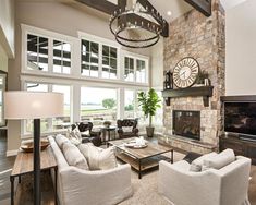 a living room filled with furniture and a large clock mounted to the wall above it