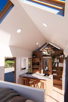 the interior of a house with wood and white walls, ceiling lights, and open kitchen area