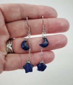 "These genuine moon and star shaped Lapis Lazuli stones are simply wrapped with 24 gauge stainless steel wire and dangle by stainless steel chain. 100% stainless steel earring hooks. They hang from an adjustable 1.25\" stainless steel chain, so you can switch up the length between the stones.  The earrings will come on an earring card with silicone earring backs, and packaged in a charming box, perfect for easy gifting! Lapis Lazuli is a deep blue metamorphic rock used as a semi precious stone t Celestial Teardrop Earrings Gift, Celestial Teardrop Earrings For Gift, Celestial Star-shaped Crystal Earrings For Gift, Celestial Star-shaped Crystal Earrings Gift, Celestial Star-shaped Crystal Earrings, Celestial Drop Earrings With Star Charm, Celestial Star Charm Round Earrings, Celestial Dangle Earrings With Star Charm, Crescent Earrings With Star Charm As Gift