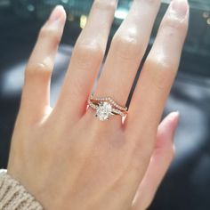 a woman's hand with a ring on it and a diamond in the middle