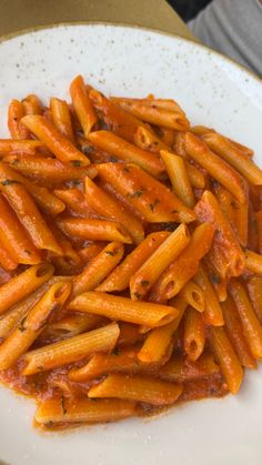 a white plate topped with pasta covered in sauce