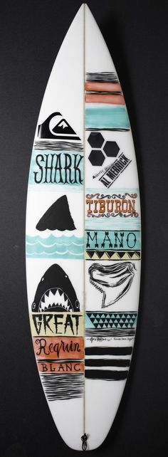 a white surfboard with different types of logos on it