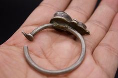 Silver ear ornaments. The hoops are made of silver wire and the bezel is decorated with Turquoise. Excellent workmanship with a great patina for its age. This is a rare Museum piece. This particular design is worn in pairs by women and single by men from Kham in East Tibet. These pieces might have been handed down to generations. *wear and tear as per age, intact. Combined Weight: 16 grams Ring Size: 39mm Origin: Early 19th c Tibet Antique Brass Chandbali Jewelry, Traditional Engraved Hoop Earrings Gift, Vintage Oxidized Finish Toe Ring Jewelry, Antique Hand Forged Jewelry For Ceremonies, Traditional Hand Forged Jewelry For Wedding, Traditional Hand Forged Wedding Jewelry, Antique Oxidized Chandbali Jewelry, Hand Forged Silver Traditional Jewelry, Antique Oxidized Finish Chandbali Jewelry