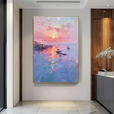 a large painting hanging on the wall in a hallway next to a vase with flowers