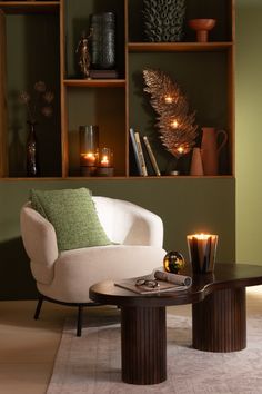 a living room filled with furniture and candles