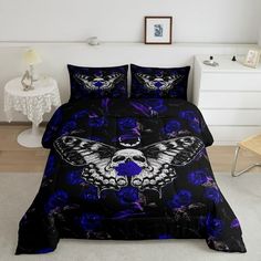 a bed with blue flowers and a butterfly on it